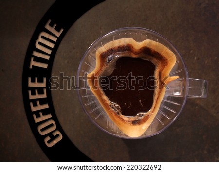 Cup of Dripping fresh hot coffee, blended coffee on paper filter, with coffee time text banner