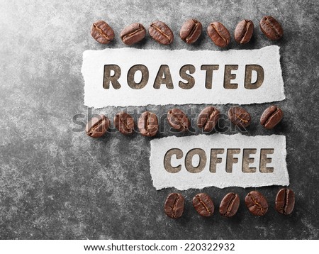 Coffee crop beans with 100 percent arabica  paper on wood texture background
