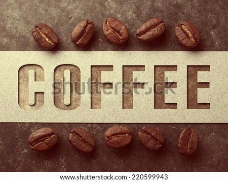 Coffee crop beans with paper and text on wood texture, vintage color background