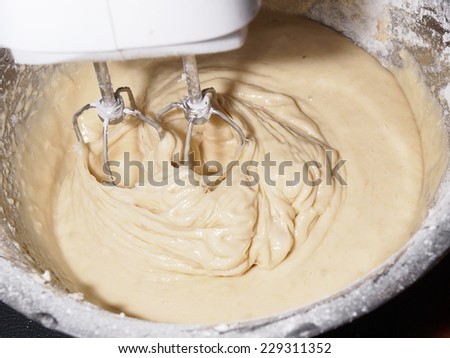 Mixing egg, banana, cake flour in bowl with motor mixer, baking banana cake