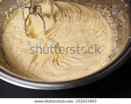 Mixing butter sugar and egg yolk with mixing machine, homemade bakery