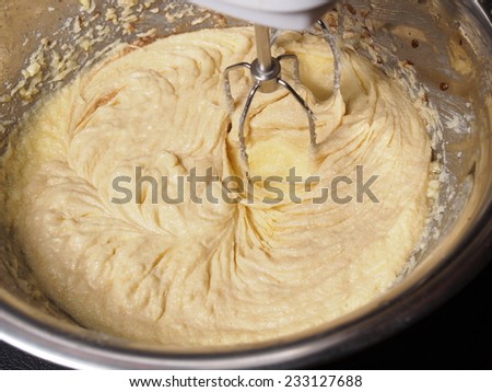 Mixing butter sugar and egg yolk with mixing machine, homemade bakery