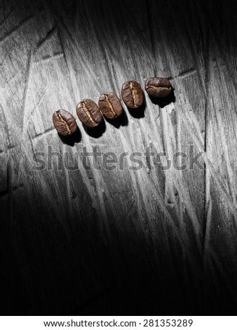 Coffee crop beans on wood texture background