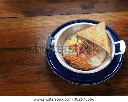 Sunny Side Up with sausage ham and garlic bread