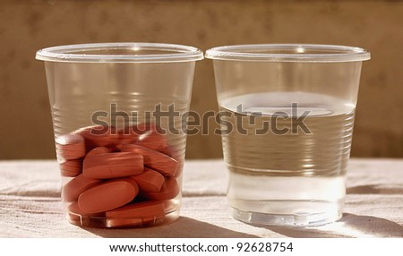Pills with cup of water