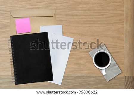 black book on table with envelop and note on table
