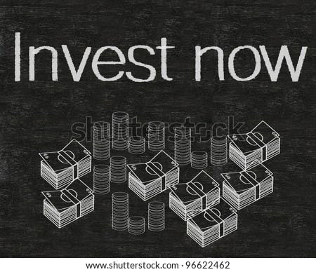 invest now written on blackboard with money