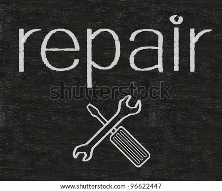 repair written on blackboard with tool sign