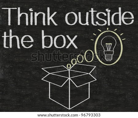 thinking outside the box written on blackboard background
