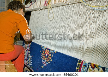 Young woman working at the loom. Greek national carpets in Epirus, north Greece