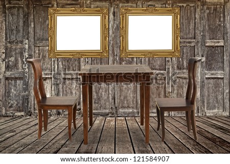 Vintage photo frame and furniture in wooden room