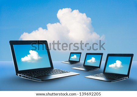Laptop access to the clouds system. Cloud Computing concept.