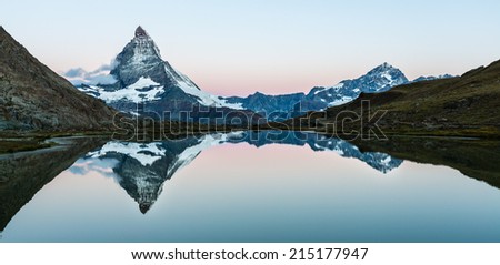 Mirror Lake. Reflection of the Matterhorn and Dent Blanche in Riffelsee at blue hour, minutes before sunrise.