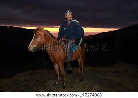 JAVA,INDONESIA-September 20:Unidentified man with the horse for tourist rent at Mt.Bromo on September 20,2012 in Indonesia.Mt. Bromo is an active volcano and part of the Tengger massif, in East Java.