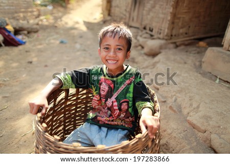 Bondowoso, INDONESIA - September 15: Unidentified poor kid plays in basket at school on September 15, 2012. Bondowoso involves cultures from different nations.There is a big Arabic there for long time