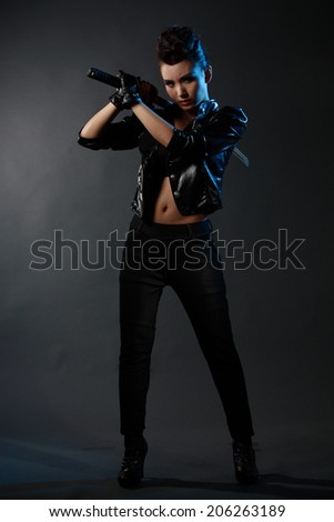 Beautiful woman in leather clothing holding saber