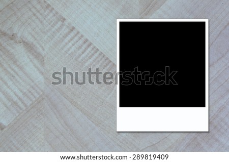 blank polaroid photo frame on brown wood plank background,polaroid frame on wood