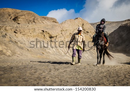 EAST JAVA,INDONESIA-MAY 05 : Tourists ride the horse at Mount Bromo, The active volcano is one of the most visited tourist attractions on May 05,2013 in East Java, Indonesia.