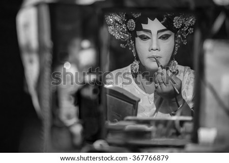 BANGKOK - OCTOBER 16: A Chinese opera actress painting mask on her face before the performance at backstage at major shrine in Bangkok\'s chinatown on October 16, 2015 in Bangkok,Thailand