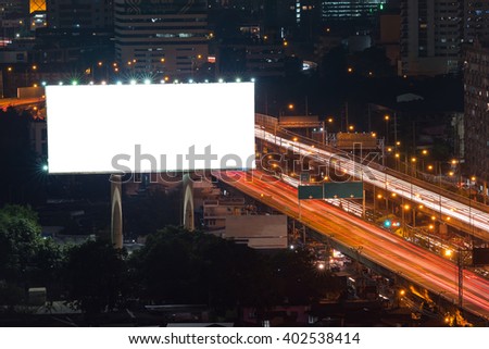 Blank billboard ready for new advertisement at expressway at night in downtown city