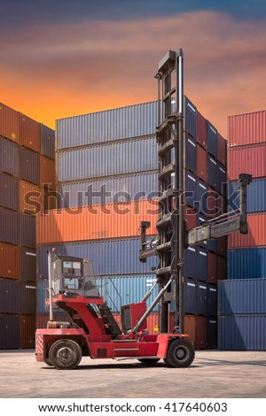 Forklift truck and cargo container in shipping yard for transportation import,export, logistic industrial with container stack in background