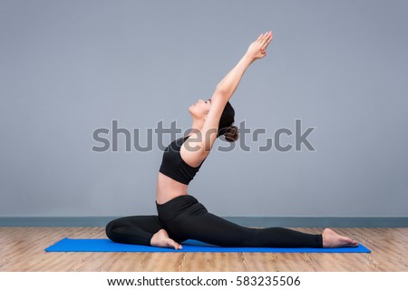 Young asian woman practicing yoga pose at yoga healthy sport gym, yoga and meditation have good benefits for health. Photo concept for Yoga Sport and Healthy lifestyle
