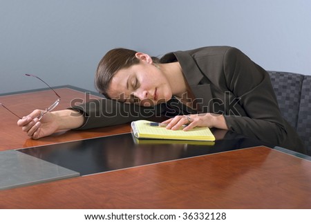 Business woman sleeping on a conference table.