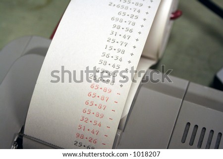 A adding machine tape with some numbers showing
