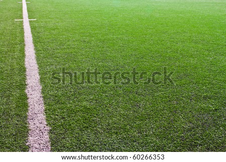green grass with white line of football field