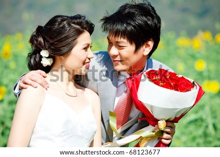 Bride and groom seeing each other in sunflower garden