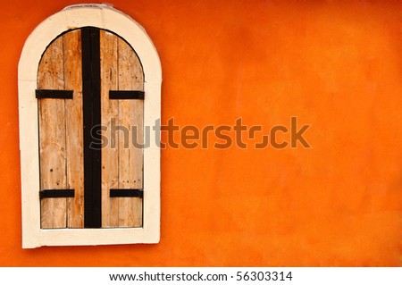 Window on orange cement wall
