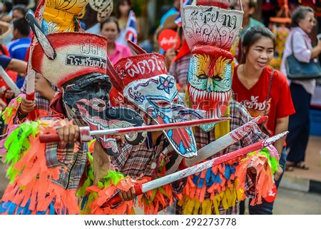 Loei, Thailand - June 27, 2015 : People are dressing with colorful clothes and put the hand made mask which made from wood or threshing bamboo in ghost mask festival or 