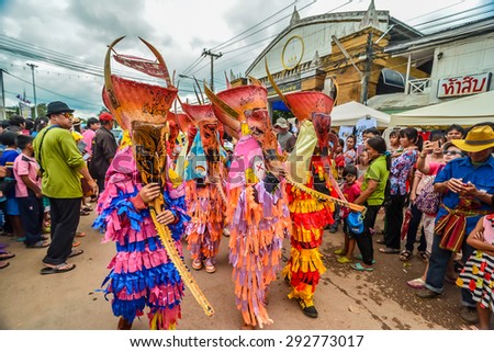 LOEI , Thailand - JUNE 27 : Unidentified men wear ghost costumes at Ghost Festival (Phi Ta Khon - a masked procession celebrated by Buddhist) on June 27, 2015 in Loei Province, Thailand.