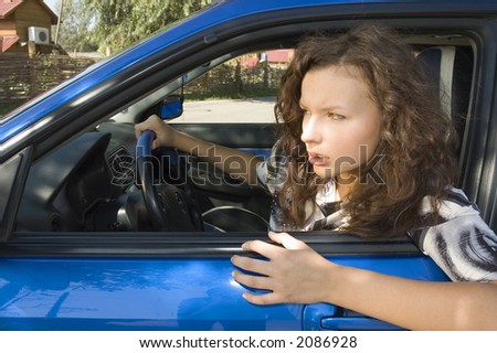 The girl at the wheel in interior of the car