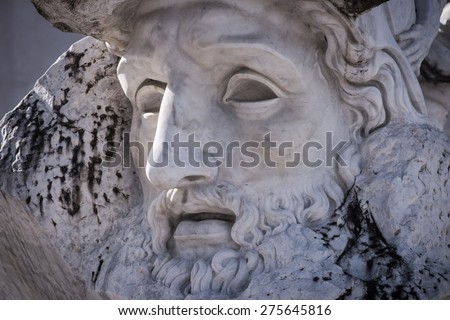 white marble sculpture of a face in a sculpture workshop