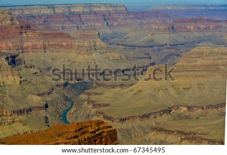 The  Colorado river over the course of millions of years has cut through nearly  a mile of rock.