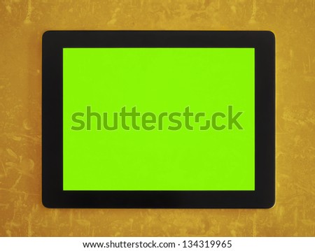 green screen tablet on orange grunge background