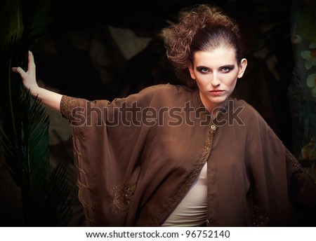 Blonde woman in jungle scenery