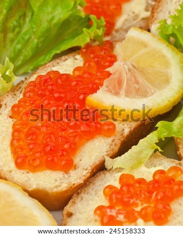 red caviar and lemon on bread