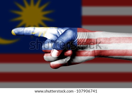 Human hand point with finger in Malaysia national flag