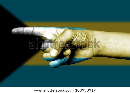 Human hand point with finger in Bahamas national flag