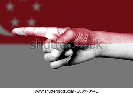 Human hand point with finger in Singapore national flag