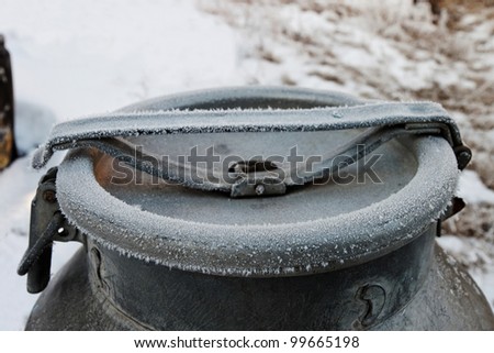 closed frozen milk bucket in the winter