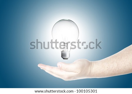 Light bulb in floating on Man\'s hand. Concept for new ideas