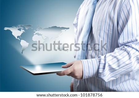 Business man holding touch screen tablet PC with 3D world map raising from the screen. Concept for connectivity