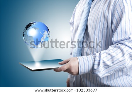 Businessman touch tablet PC screen with blue internet globe coming out from the screen. Concept for internet and connectivity