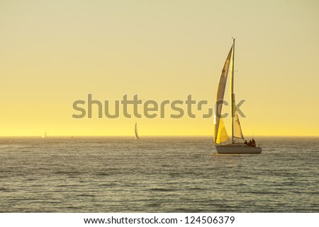 Sailboat on ocean at sunset