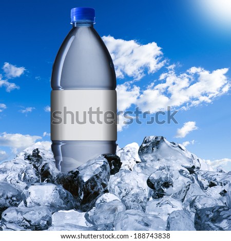 Water bottle on ice cubes with blue sky background