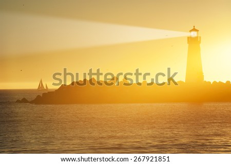 Lighthouse and surf boat with light beam at sunset