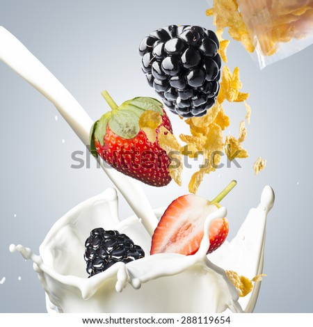 Corn Flakes With Strawberry and Blackberry Falling into Milk Splash